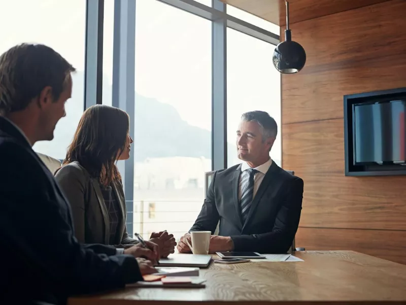 Professionals discussing highest paying jobs in the UK during a corporate interview.