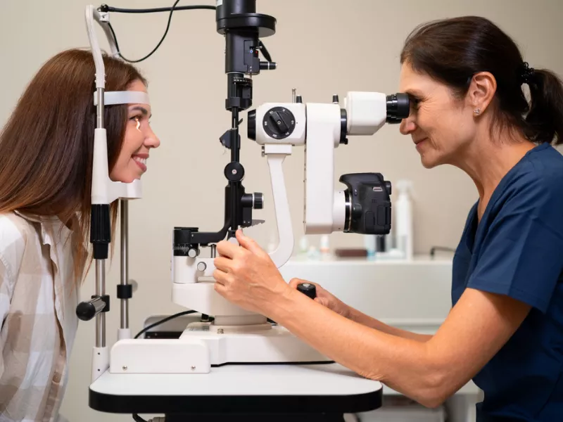 Eye specialist examining a patient in one of the highest paying jobs in the UK.